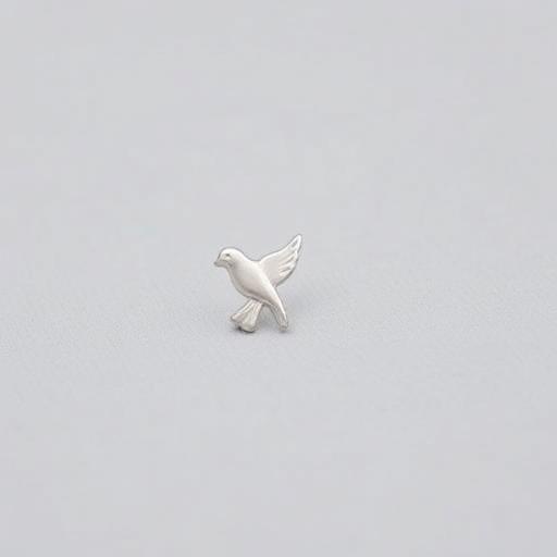 A small silver memorial dove lapel pin